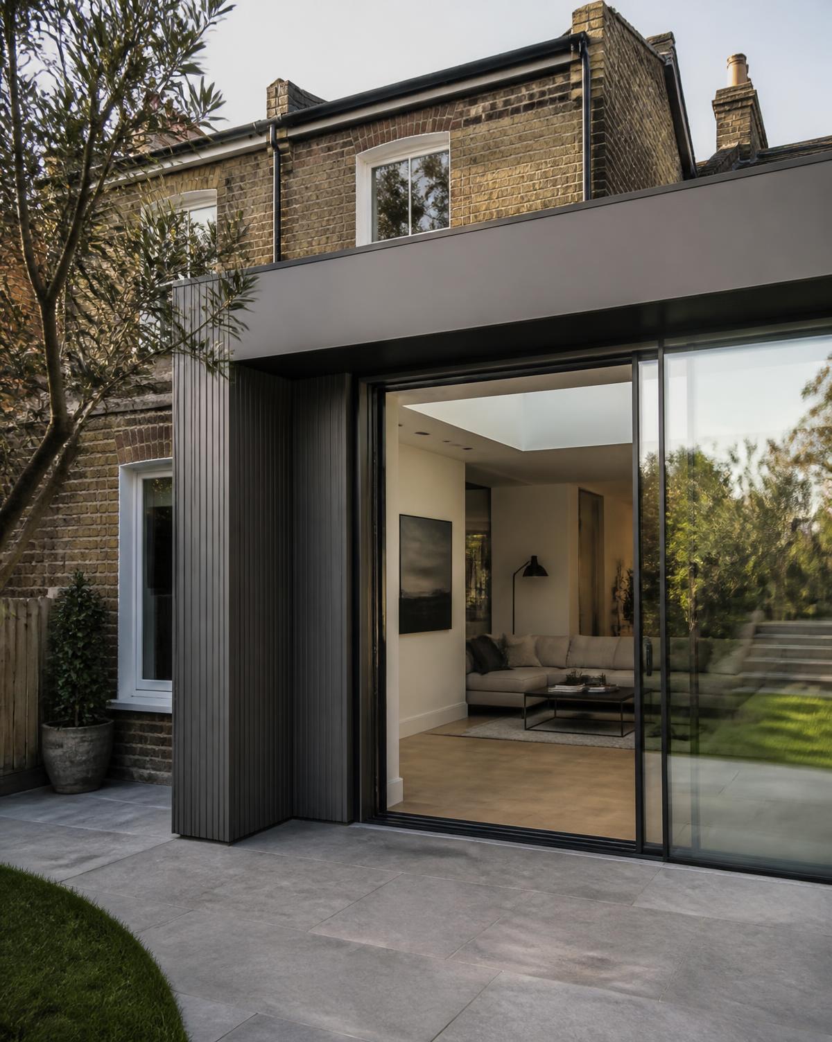 Contemporary rear addition with full-height sliding glass doors